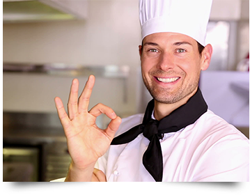 Outside Catering Norfolk, chef smiling and giving the OK sign.